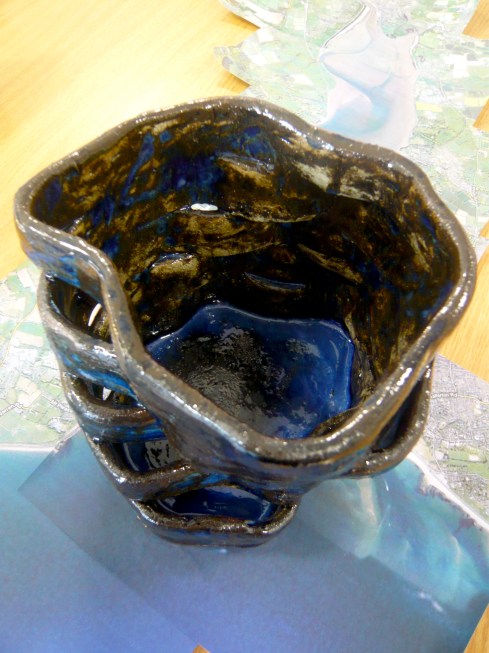 Stoneware structure reflecting wind patterns  and turbulent seas